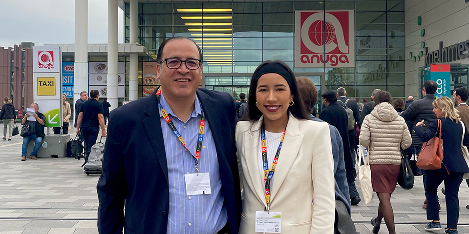 Man and woman in front of a large building.